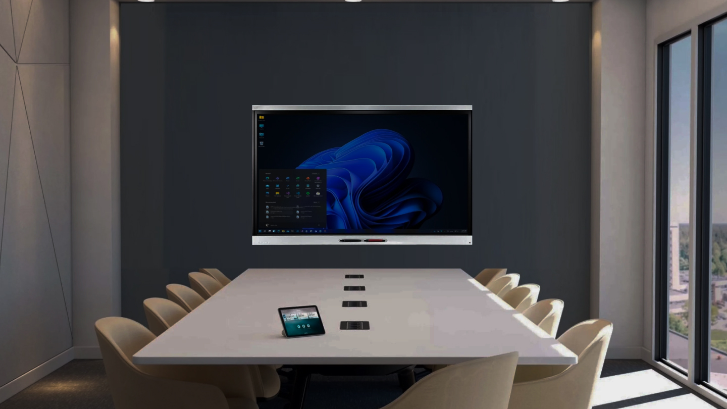 Conference room with a large screen and chairs around a table